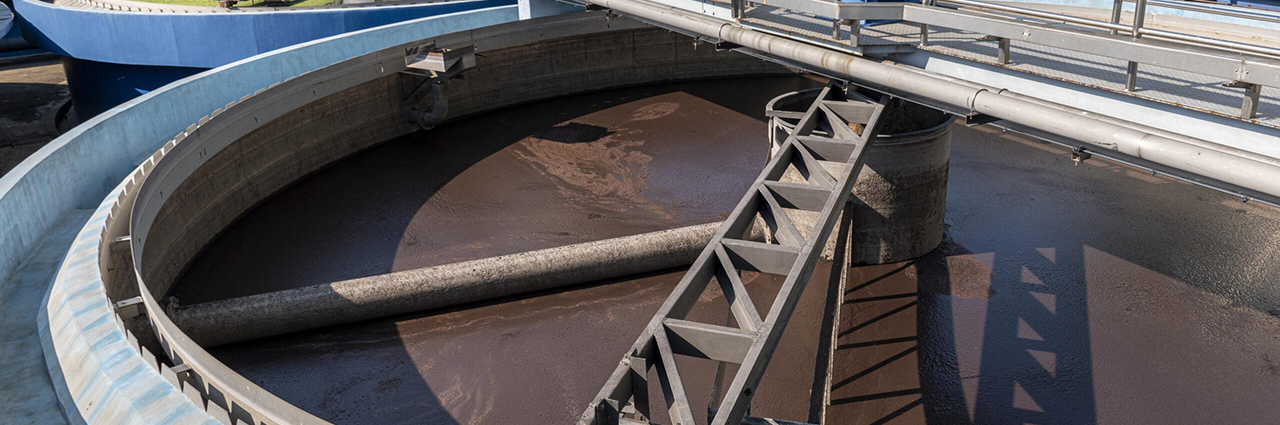 Wastewater clarifier using Load Controls PMP-25 for scraper drive motor monitoring, sludge processing, and process control.