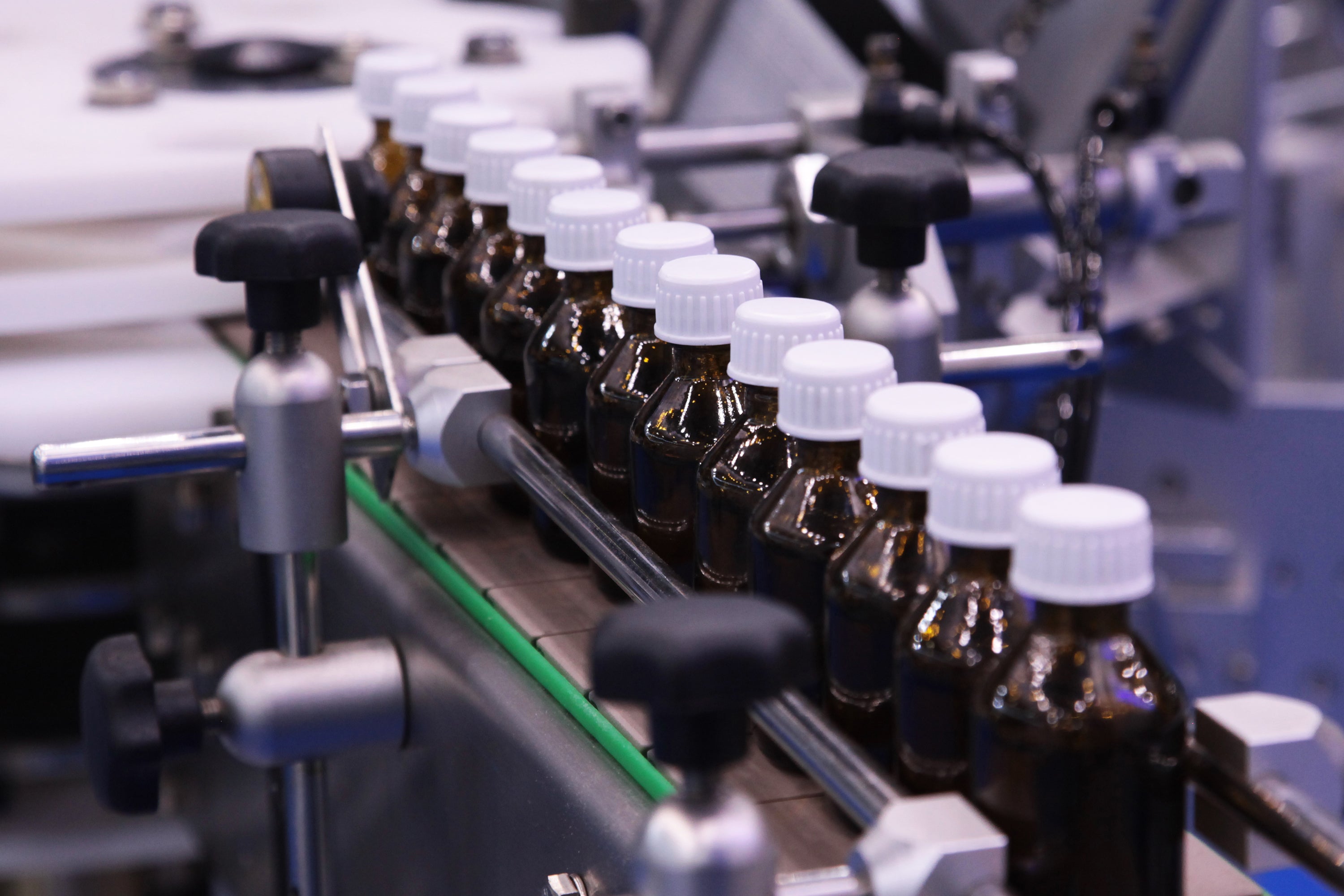 Automated pharmaceutical manufacturing line for precision bottle filling, packaging, and quality-controlled production.